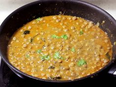 a black pot filled with food on top of a stove