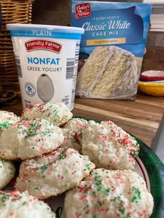 a plate full of cookies next to a container of plain cheese cake mix