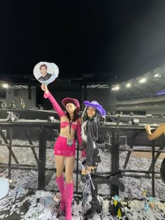 two women dressed up in costumes at a baseball game