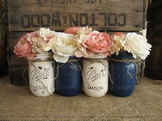 three mason jars with flowers in them