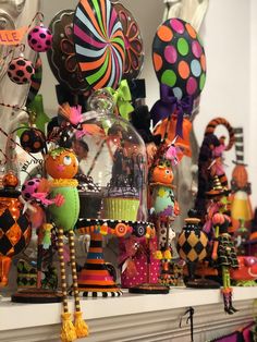 many colorful balloons and decorations on a mantel