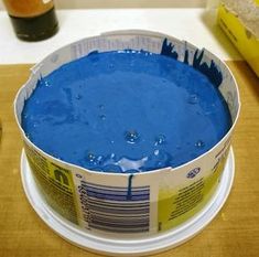 a bucket of blue liquid sitting on top of a table