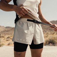 Advanced 3-in-1 short with a built-in belt pack and liner for long distance runs. The shell is constructed from an extremely durable stretch ripstop material. The liner is constructed from Silver-Lite™ to provide an incredibly lightweight chafe guard while running. The built-in belt pack sits on the back waistband and Running Outfit Men, Urban Running, Gym Wear Men, Belt Pack, Long Distance Running, Running Shorts Men, Beige Outfit, Running Belt, Active Outfits