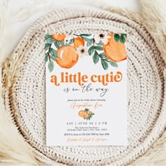 an orange themed baby shower is shown on a white background with greenery and flowers