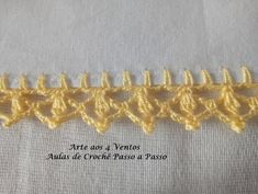 the crochet is being used to make an applique on a piece of cloth