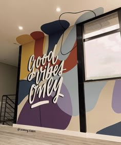 a mural on the side of a building that says good burgers comer with an abstract design