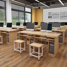 an empty classroom with desks and computers