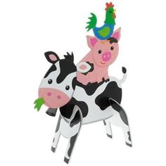 a cow with a bird on its back is standing next to another cow that has a green hat on it's head