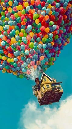 a house is floating in the air with balloons