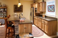 a kitchen with wooden cabinets and an island in front of the stove top oven is shown