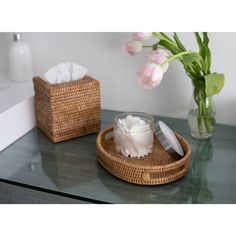 a table with two baskets and some flowers on it, one is filled with tissues