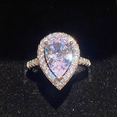 This Stunning Water Drop Simulated Diamond Ring Set In A Tension Mount Has A 3.47ct Center Stone With .5ct Halo White Gold Plated Silver Ring & Stamped S925. This Stones Show Quality Is Almost Indescribable, The Photos Can’t Even Pick Up All The Rainbow & Kaleidoscope Colors It Shows. The Photos Posted Show White, Purple, Pink & Silver But Are Missing The Beautiful Blues. Even The Mount Is Gorgeous! Size 6,7,8,9 Cubic Zirconia Crystal Ring With Halo Setting For Proposal, Dazzling Cubic Zirconia Jewelry For Proposal, Silver Teardrop Wedding Ring With Halo Setting, Teardrop Shaped Brilliant Cut Jewelry For Promise Ring, Luxury Teardrop Rings With Halo Setting, Pear-shaped Cubic Zirconia Ring With Center Stone, Teardrop Cubic Zirconia Jewelry For Proposal, Diamond White Halo Ring For Wedding, Luxury Teardrop Halo Setting Ring