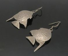 "MEXICO 925 Sterling Silver - Vintage Hammered Fish Motif Dangle Earrings- EG8498  MEXICO 925 Sterling Silver - Vintage Hammered Fish Motif Dangle Earrings- EG8498  Jewelry Type:         Earrings   Metal Type:            925 Silver  Metal Size:             2.5\"  Stone Type:            N/A  Condition:              N/A  Jewelry Weight:     13.1 Grams  PLEASE NOTE: THIS ITEM IS PRE-OWNED. ALTHOUGH MOST ITEMS ARE IN VERY GOOD CONDITION, SOME MAY NEED CLEANING AND/OR MINOR REPAIRS. WE MAKE A VERY STRONG EFFORT TO UPLOAD CLEAR PICTURES. PLEASE INSPECT ALL PICTURES AND ASK ALL QUESTIONS YOU MAY HAVE PRIOR TO MAKING A PURCHASE. NOT ALL STONES ARE GENUINE, SOME ARE ENHANCED OR CREATED." Silver Fish-shaped Earrings With Ear Wire, Handmade Silver Fish-shaped Earrings, Silver Sterling Fish-shaped Earrings, Silver Fish-shaped Sterling Silver Earrings, Silver Fish-shaped Earrings With Fish Hooks, Nickel-free Silver Fish-shaped Earrings, Fish Motif, Earrings Metal, Beautiful One