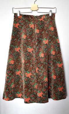 "Vintage 70's midi circle skirt that goes on the high waist. Has orange and green floral print on a brown background. Fastens by a centre back zipper. Beautiful burgundy lining. The fabric is velvety, plush-like. A great boho, preppy skirt. Brand: Abo of Scandinavia Material: tag is missing but it looks like a synthetic blend Size: tagged size 40 but it is not clear according to which national sizing system. Looks like an S-M. For a best fit, please refer to the measurements below. Appr. Measurements (taken with skirt lying flat, please double waist and hips): waist: 13,5\"/34,5cm hips: 21\"/53,5cm total length: 28\"/71cm Condition: Item is vintage and pre-worn. Has no visible signs of wear except a small tear on the lining by the zipper (see last photo). No holes, no stains, no pulls. Zip 70s Fashion Skirt, Midi Circle Skirt, Preppy Skirt, Floral Print Midi Skirt, 80s Outfit, Green Fits, Printed Midi Skirt, Circle Skirt, 70s Fashion