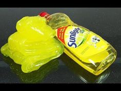 a bottle of sunflower oil sitting on top of a table next to a yellow plastic frog