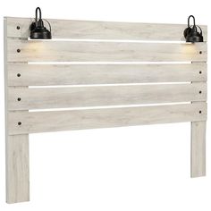 a white wooden headboard with two lights on each side and one light at the top