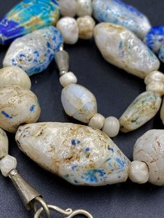 The Rare and Unique Beads necklace of Ancient Rough Rock Crystals Almost every Bead is Beautifully Carved and Beautifully painted with Blue color Rare and unique Item for collection Fast and Free shipping service Artisan White Single Strand Beads, Unique White Jewelry For Art Collection, White Artisan Beaded Necklaces With Oval Beads, Artisan Czech Glass Large Beads, Artisan Large Czech Glass Beads, Artistic Beaded Necklace With Large Beads, Artisan White Gemstone Beads Necklaces, Unique Natural Stone Beaded Necklace, Artisan Single Strand Czech Glass Beaded Necklace