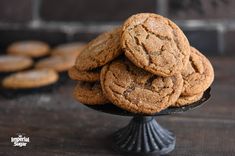 a pile of cookies sitting on top of a black plate