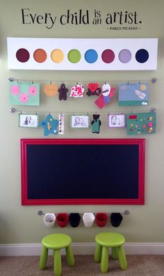 a child's playroom with two stools and a chalkboard