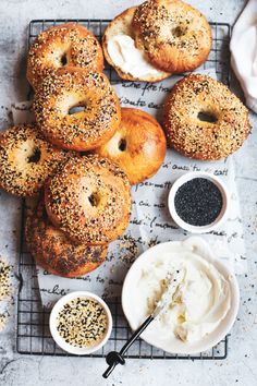 bagels with cream cheese and poppy seed sprinkles on a cooling rack