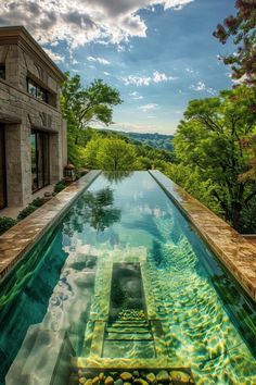 an outdoor swimming pool surrounded by trees and water