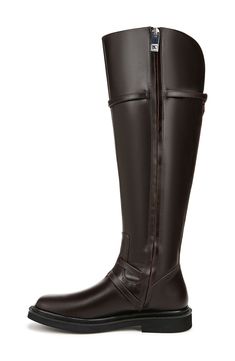 a pair of brown boots with zippers on the side and black outstep