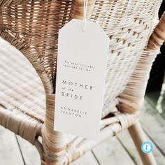 a wicker chair with a white mother of the bride tag hanging from it's back