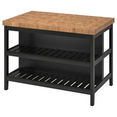 a wooden counter top sitting next to a shelf with two shelves on each one side