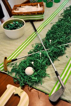 a golf themed table setting with green and white decorations