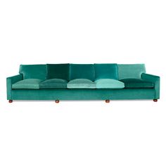 a green couch with pillows on it