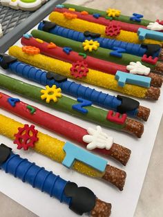 some colorful candy sticks are lined up on a table