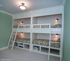 bunk beds are lined up against the wall in this room with green walls and carpeted flooring