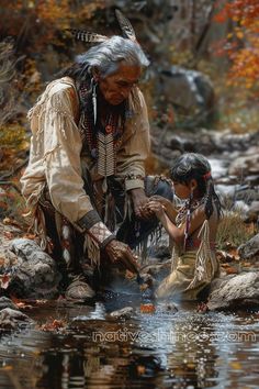 This touching artwork captures a sacred moment between generations, as an elder Native American teaches a young child the spiritual significance of water. Set amidst a vibrant autumn backdrop, the elder gently guides the child's hands toward the reflective surface of a stream, symbolizing the passing down of knowledge, tradition, and respect for nature. Their traditional attire, adorned with beads and feathers, adds cultural depth, while the serene environment evokes peace and connection to the earth. This piece speaks to the importance of heritage, wisdom, and the timeless bond between the old and the young. Native American Paintings, Native American Warrior, Native American Images, Native American Men, American Photo, Wilde Westen, Native American Pictures, Native American Artwork, Native American Photos