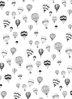 black and white hot air balloons flying in the sky