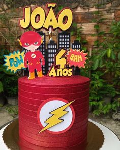 a red birthday cake with the flash logo on top