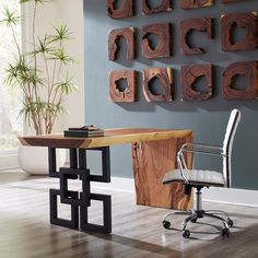 a chair and desk in front of a wall with wood carvings on the walls behind it