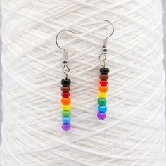 Show your pride with these Philly rainbow beaded earrings! These minimalist beaded pendants have glass beads in the six rainbow colors plus black and brown to represent people of color. Earrings are stainless steel, shipped sterile, and come with rubber backs. Hand assembled. Need more earrings? Check them out here: https://www.etsy.com/shop/QuietMischief?section_id=31782094 More rainbows here: https://www.etsy.com/shop/QuietMischief?search_query=rainbow Nickel-free Rainbow Round Beaded Earrings, Adjustable Rainbow Earrings With Tiny Beads, Simple Beaded Earrings, Flag Lgbt, Rainbow Flag Lgbt, Beaded Pendants, Color Earrings, Beaded Jewellery, Rainbow Beads