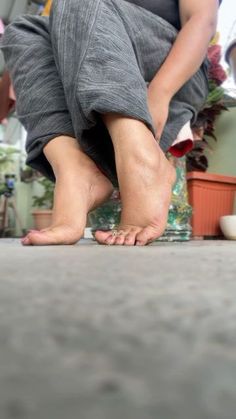 a person standing on the ground with their feet in the air and one foot up