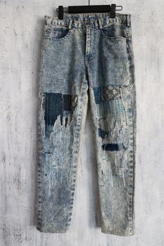 an old pair of jeans hanging on a wall