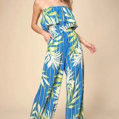 Lulu's Montane Royal Blue Tropical Print Strapless Jumpsuit Size Small Blue And Sage Green Striped Print Intermingles With A Trendy Green And White Tropical Print Across This Lightweight, Woven Jumpsuit With An Elasticized Strapless Neckline And Ruffled Flounce Bodice. High, Elasticized Waist, With A Faux Tie Accent, Tops Wide-Cut Pant Legs With Diagonal Front Pockets. Size: S Inseam: 30” Rise: 13” Waist: 10.5” Unstretched Blue Strapless Sleeveless Jumpsuit For Vacation, Blue Strapless Jumpsuit For Vacation, Blue Strapless Jumpsuit For Spring Vacation, Blue Strapless Jumpsuit For Summer, Blue Fitted Strapless Jumpsuit For Beach, Fitted Blue Strapless Jumpsuit For Beach, Blue Floral Print Sleeveless Jumpsuits And Rompers, Casual Blue Strapless Jumpsuits And Rompers, Blue Strapless Jumpsuit For Summer Beach