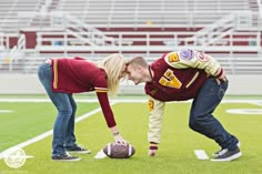 a man and woman kissing on the football field