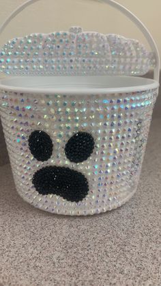 a plastic basket with a face painted on it