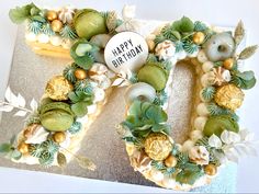 a decorated letter shaped cake sitting on top of a table