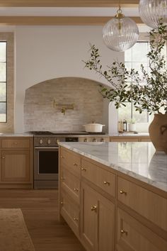 a large kitchen with wooden cabinets and marble counter tops, along with an island in the middle