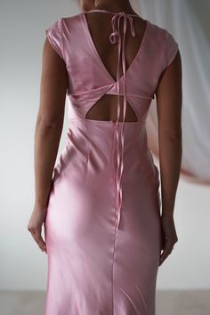 the back of a woman's pink dress