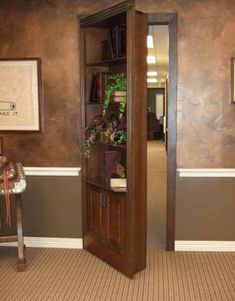 an open door leading into a living room with brown walls and carpeting on the floor