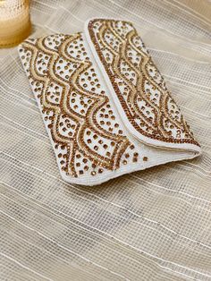 Thank you so much for visiting my shop ! Beautiful and Elegant Crystal handcrafted clutch can be a perfect fit for any occasion or event, Specially for bride. Traditional Gold Evening Bag With Pearl Embroidery, White Hand Embellished Clutch For Party, White Festive Clutch For Party, White Clutch For Wedding And Festivals, Festive White Clutch For Party, Festive Gold Evening Bag With Pearl Embroidery, Gold Evening Bag With Pearl Embroidery For Festivals, Gold Embroidered Clutch For Festivals, Festive White Clutch With Pearl Embroidery