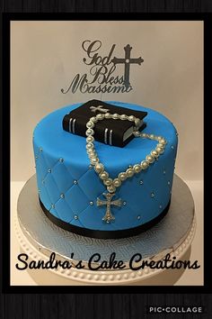 a blue cake with a cross and bible on it