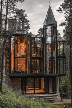 an unusual house in the woods surrounded by trees