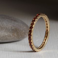 Rich red garnet eternity ring that makes a bold statement in your choice of Gold Handmade and Set with exquisitely beautiful natural indian garnets handpicked for the best color and consistency Perfect for stacking with your other rings this ring will sit flush with most rings. Ideal as an anniversary gift for lovers of the color Red. Get this ring today and enjoy it for the rest of your life! or treat someone with an everlasting gift. - Made to Order, perfectly finished, Fast shipping fully ins Classic Red Eternity Band As A Gift, Red Garnet Stackable Anniversary Rings, Red Garnet Stackable Rings For Anniversary, Red Gemstone Eternity Band, Red Garnet Stackable Rings, Red Round Eternity Band As Gift, Red Eternity Band Gift, Stackable Red Garnet Rings, January Birthstone Rings